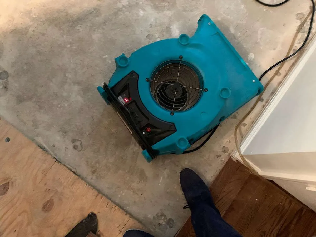 Air mover drying subfloor during Commercial Water Damage Restoration in Waco